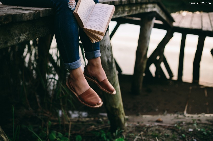 女孩在湖边阅读的图片
