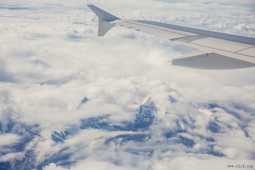 高空云层上的飞机机翼图片