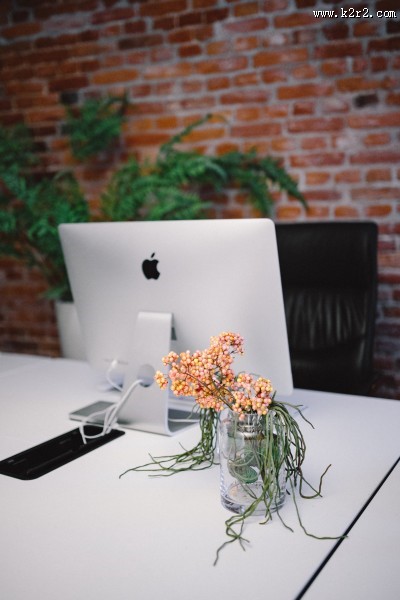 放着台式苹果电脑的办公室图片
